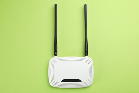 Modern WiFi router on green background, top viewの写真素材