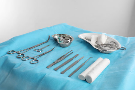Different surgical instruments on table against light backgroundの写真素材