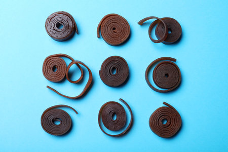 Delicious fruit leather rolls on light blue background, flat layの写真素材