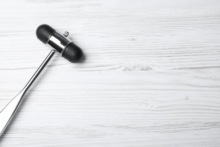 Reflex hammer on white wooden background, top view with space for text. Nervous system diagnosticの写真素材
