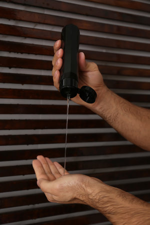 Man applying gel in shower at home, closeupの写真素材