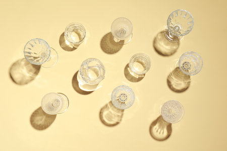 Set of empty glasses on beige background, flat layの写真素材