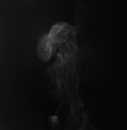 White steam rising on black background. Space for textの写真素材