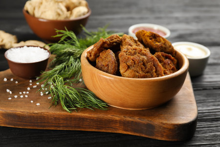 Cooked soy meat in bowl on black wooden tableの写真素材
