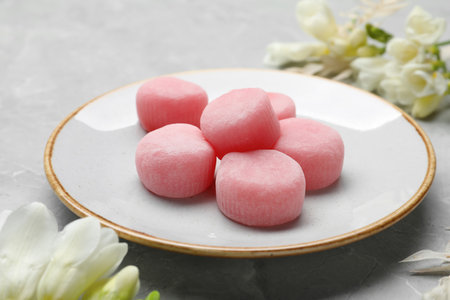 Delicious mochi and flowers on light gray marble table. Traditional Japanese dessertの写真素材