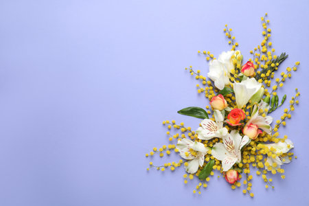 Beautiful floral composition with mimosa flowers on light blue background, flat lay. Space for textの写真素材