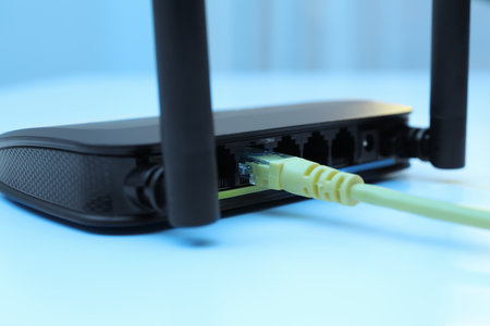 Connected cable to router on white table, closeup. wireless internet communicationの写真素材