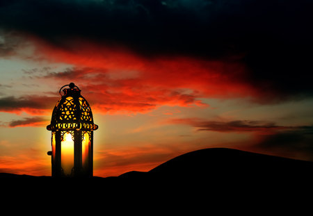 Beautiful Arabic lantern on sand at sunset, space for textの写真素材