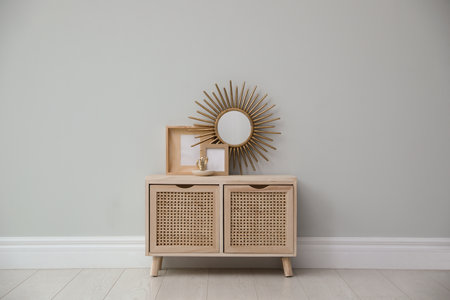 Stylish room interior with wooden cabinet near gray wallの写真素材