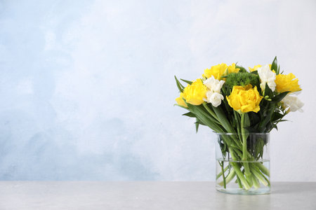 Beautiful bouquet with peony tulips on table against light blue background, space for textの写真素材