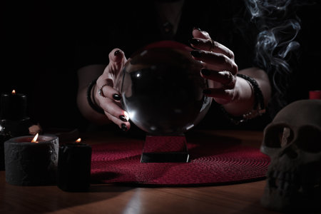 Soothsayer using crystal ball to predict future at table indoors, closeupの写真素材