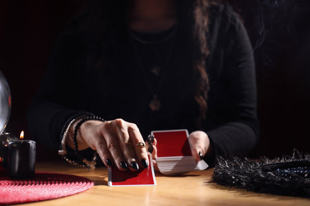 Soothsayer predicting future with cards at table indoors, closeupの写真素材