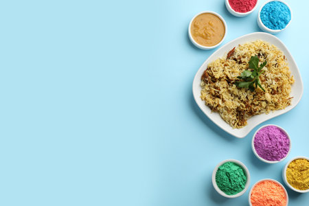 Flat lay of traditional Indian food and color powder dyes on turquoise background, space for text. Holi Festivalの写真素材
