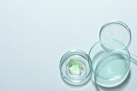 Organic cosmetic product and laboratory glassware on light background, flat lay. Space for textの写真素材
