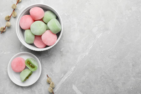 Delicious mochi and willow branches on light gray marble table, flat lay with space for text. Traditional Japanese dessertの写真素材