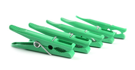 Bright green plastic clothes pins on white backgroundの写真素材
