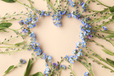 Beautiful Forget-me-not flowers on beige background, flat lay. Space for textの写真素材