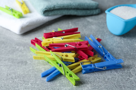 Colorful plastic clothespins on gray table, closeupの写真素材