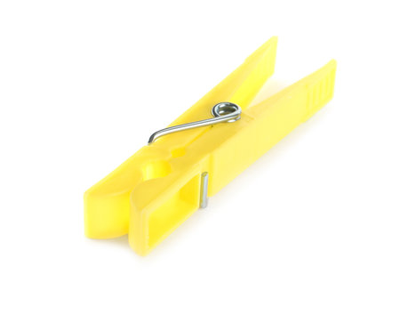 Bright yellow plastic clothespin isolated on whiteの写真素材