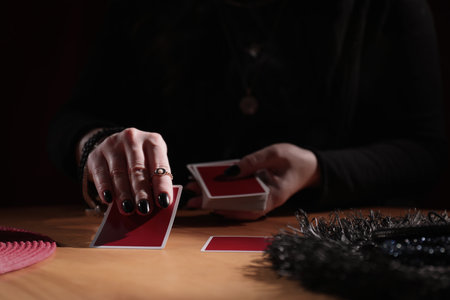 Soothsayer predicting future with cards at table indoors, closeupの写真素材