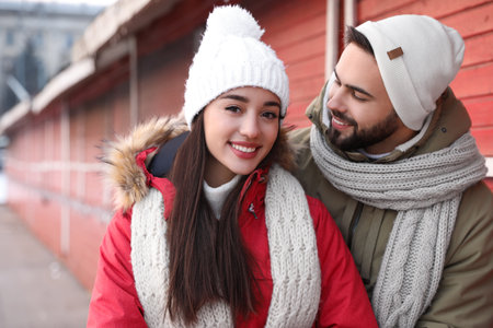 Happy young couple spending time together at winter fair. christmas celebrationの写真素材