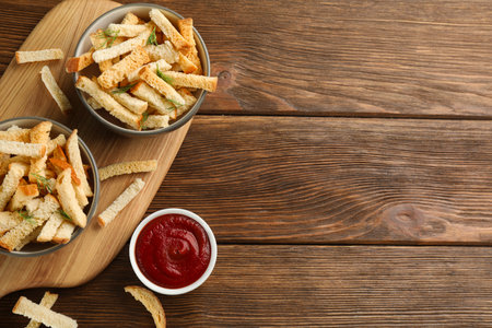 Delicious hard chucks with ketchup on wooden table, flat lay. Space for textの写真素材