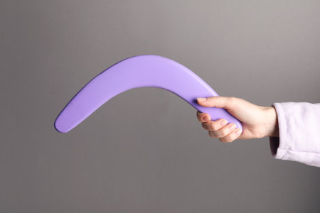Woman holding boomerang on gray background, closeupの写真素材