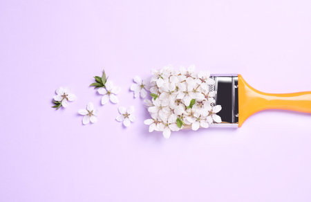 Paint brush and beautiful flowers on pale violet background, flat layの写真素材
