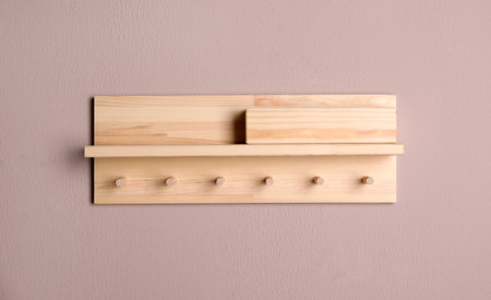 Wooden hanger for keys on color wallの写真素材