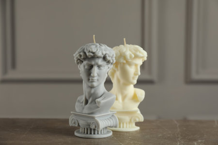 Beautiful David bust candles on gray tableの写真素材