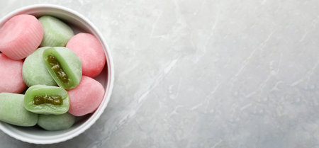 Delicious mochi in bowl on light gray marble table, top view with space for text. Traditional Japanese dessertの写真素材