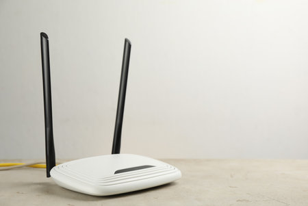 Modern WiFi router on light table. Space for textの写真素材