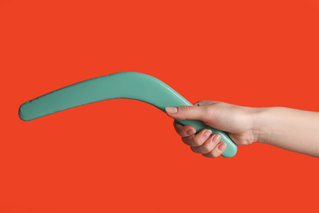 Woman holding boomerang on red background, closeupの写真素材