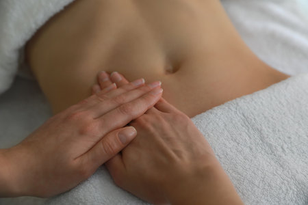Woman professional receiving belly massage, closeup viewの写真素材
