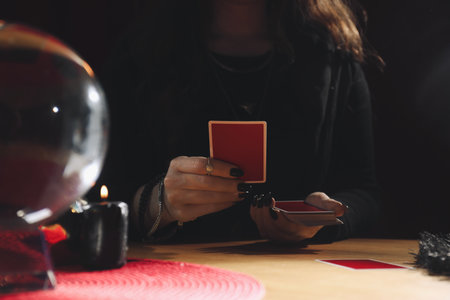 Soothsayer predicting future with cards at table indoors, closeupの写真素材