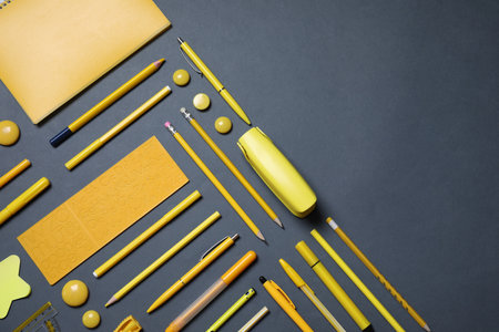 Different stationery on black background, flat lay. Space for textの写真素材