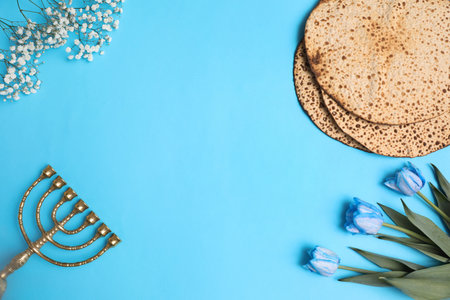 Flat lay composition with matzos on light blue background, space for text. Passover (Pesach) celebrationの写真素材