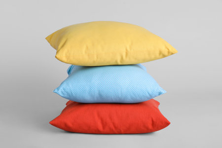 Stack of stylish soft pillows on gray backgroundの写真素材