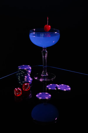Casino chips, dice and cocktail on dark backgroundの写真素材