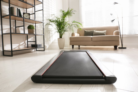 Modern walking treadmill in living room. home gym equipment