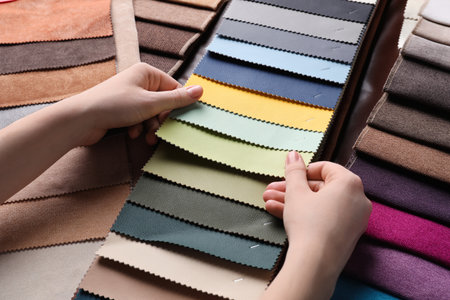 Woman choosing among colorful leather samples, closeupの写真素材