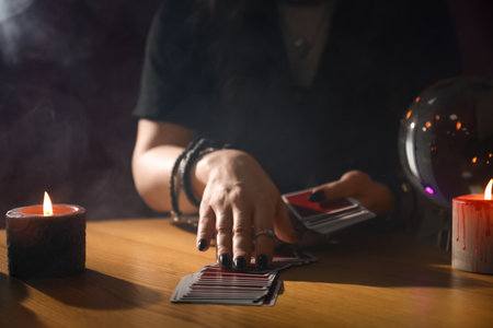 Soothsayer predicting future with cards at table indoors, closeupの写真素材
