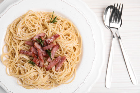 Delicious Carbonara pasta served on white wooden table, flat layの写真素材