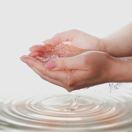 Woman holding pure water on light background, closeupの写真素材
