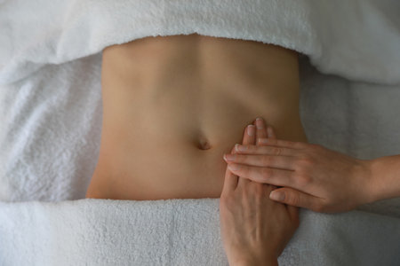 Woman professional receiving belly massage, closeup viewの写真素材