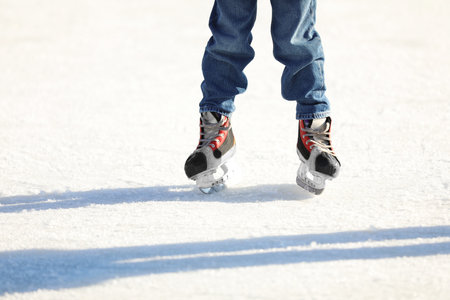 Little child at outdoor ice skating rink, closeupの写真素材
