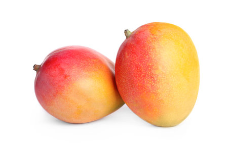 Delicious ripe juicy mangoes on white backgroundの写真素材