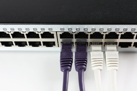 Closeup view of network switch with cables on light background. internet connection