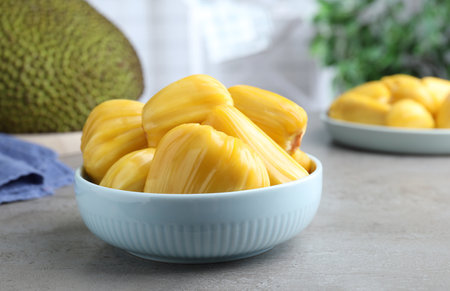 Fresh exotic jackfruit bulbs on light gray tableの写真素材