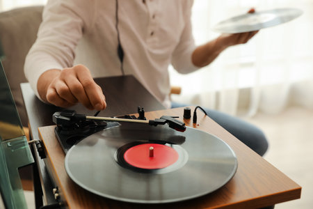 Man using turntable at home, closeup viewの写真素材
